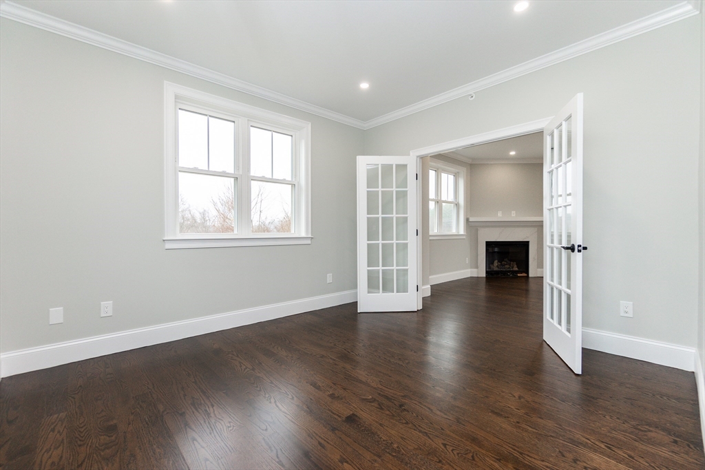 83 East Main Street Hopkinton, MA 01748 - Photo 20 of 42 an empty room with wooden floor and a window
