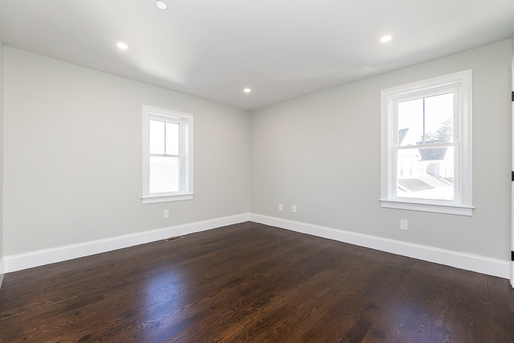 83 East Main Street Hopkinton, MA 01748 - Photo 23 of 42 an empty room with wooden floor and windows