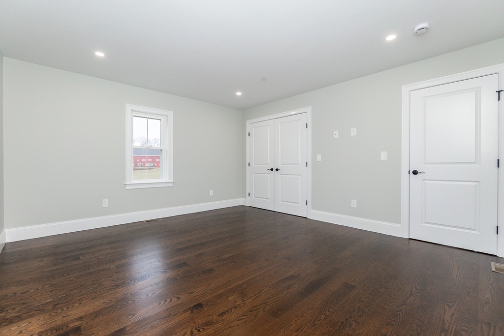83 East Main Street Hopkinton, MA 01748 - Photo 24 of 42 an empty room with wooden floor and windows