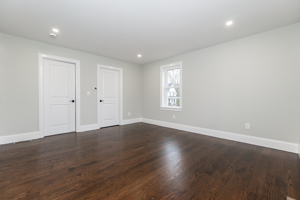 83 East Main Street Hopkinton, MA 01748 - Photo 25 of 42 an empty room with wooden floor and window