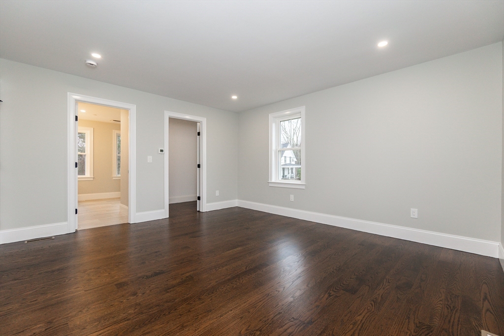 83 East Main Street Hopkinton, MA 01748 - Photo 27 of 42 an empty room with wooden floor and windows