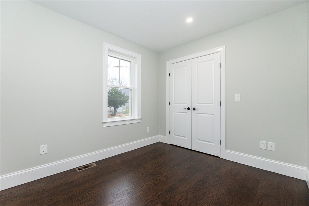 83 East Main Street Hopkinton, MA 01748 - Photo 28 of 42 an empty room with wooden floor and window