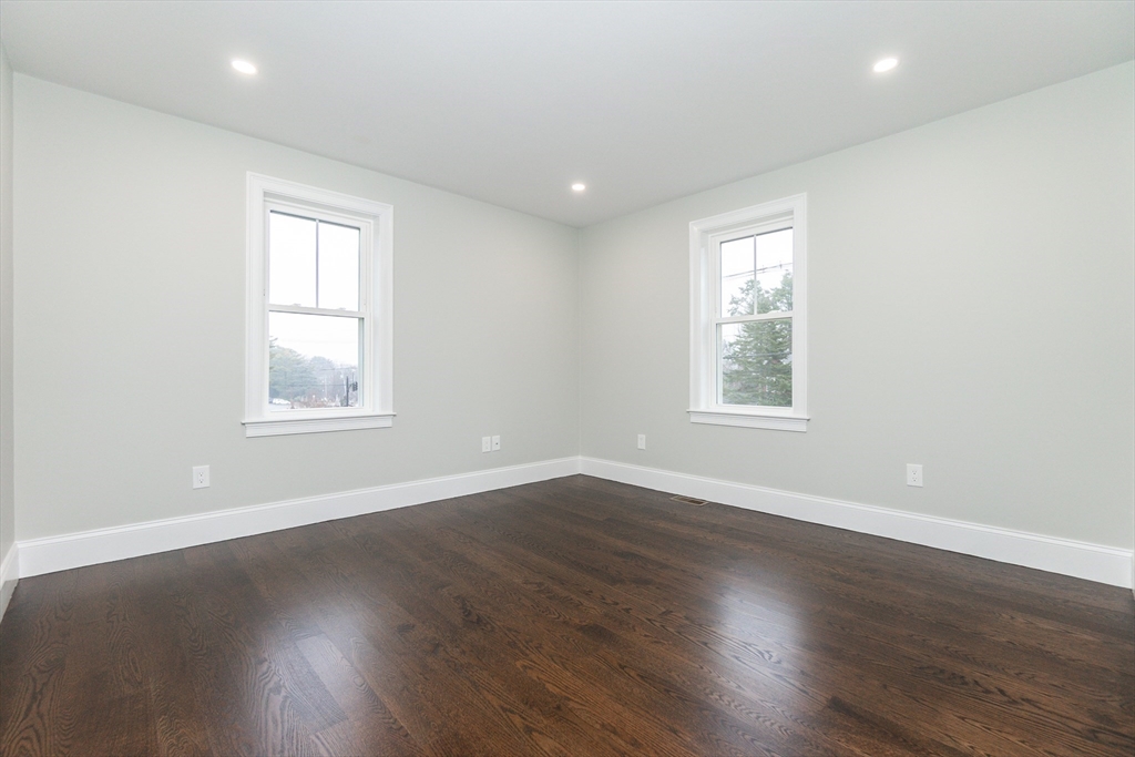 83 East Main Street Hopkinton, MA 01748 - Photo 29 of 42 an empty room with wooden floor and windows
