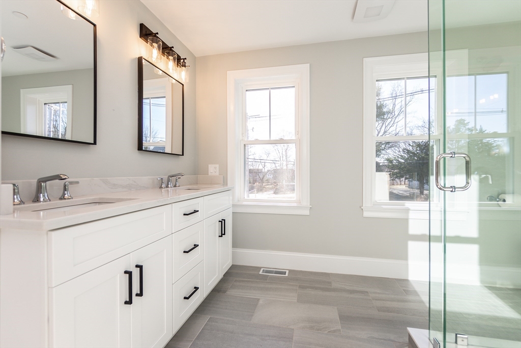 83 East Main Street Hopkinton, MA 01748 - Photo 30 of 42 a bathroom with double vanity and a mirror