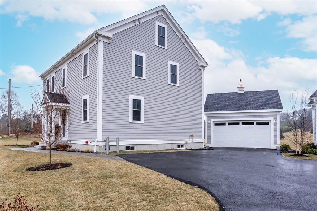 83 East Main Street Hopkinton, MA 01748 - Photo 3 of 42 a front view of a house with a yard