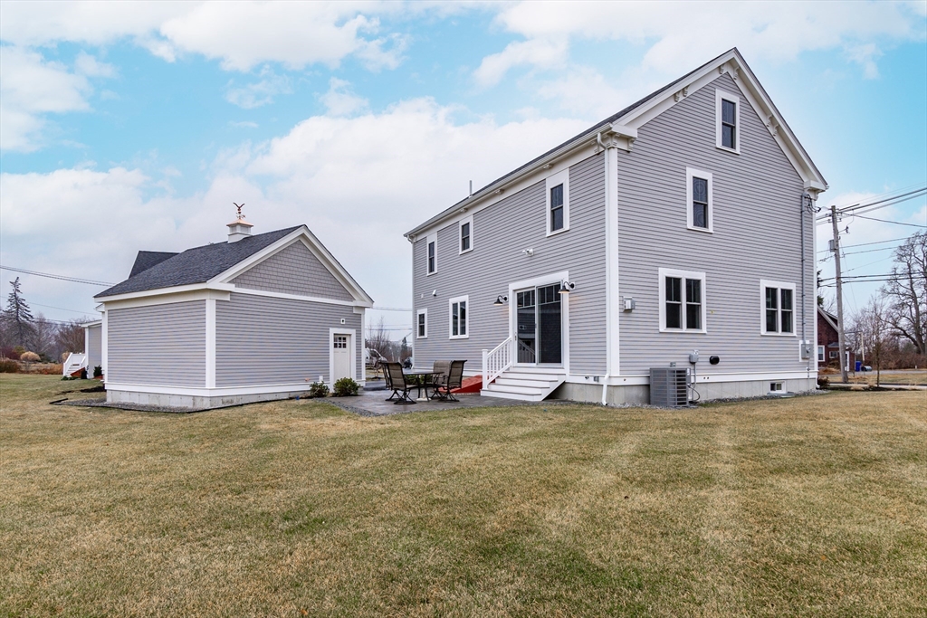 83 East Main Street Hopkinton, MA 01748 - Photo 35 of 42 a front view of a house with a yard