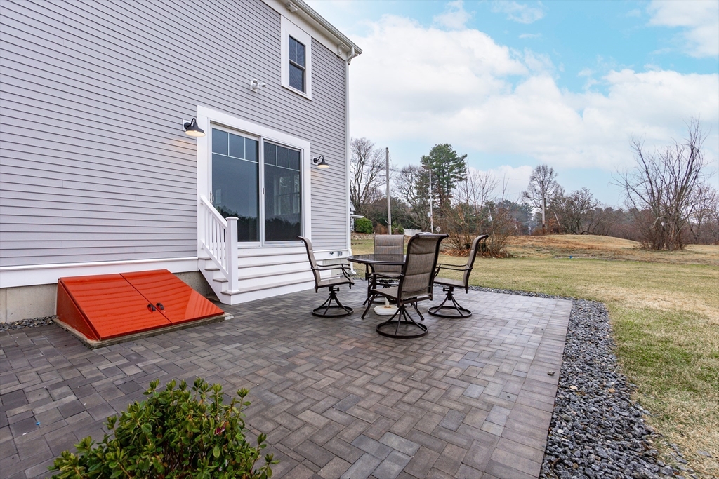 83 East Main Street Hopkinton, MA 01748 - Photo 37 of 42 an outdoor sitting area with a table and chair