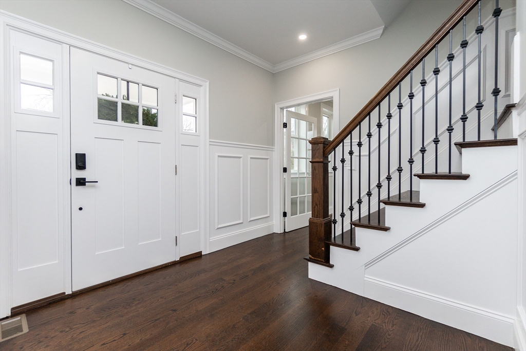 83 East Main Street Hopkinton, MA 01748 - Photo 5 of 42 a view of an entryway with wooden floor and stairs