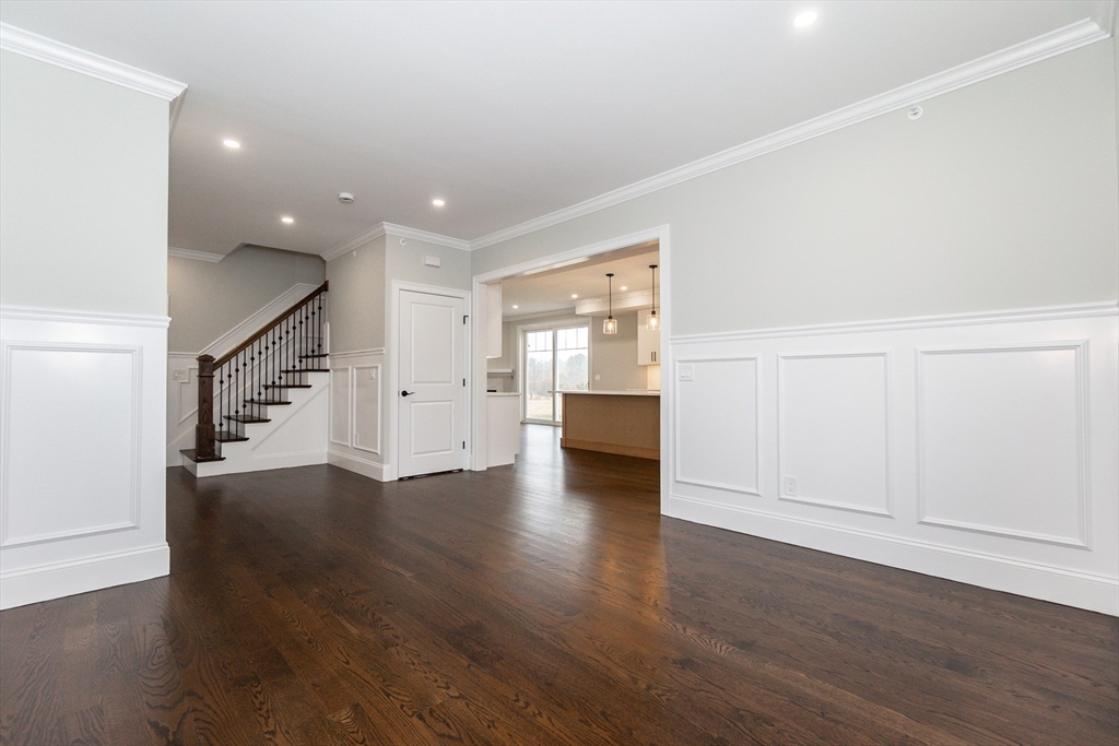 83 East Main Street Hopkinton, MA 01748 - Photo 6 of 42 a view of an empty room with wooden floor and stairs