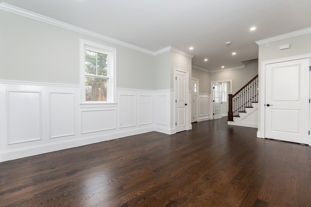 83 East Main Street Hopkinton, MA 01748 - Photo 7 of 42 an empty room with wooden floor and windows