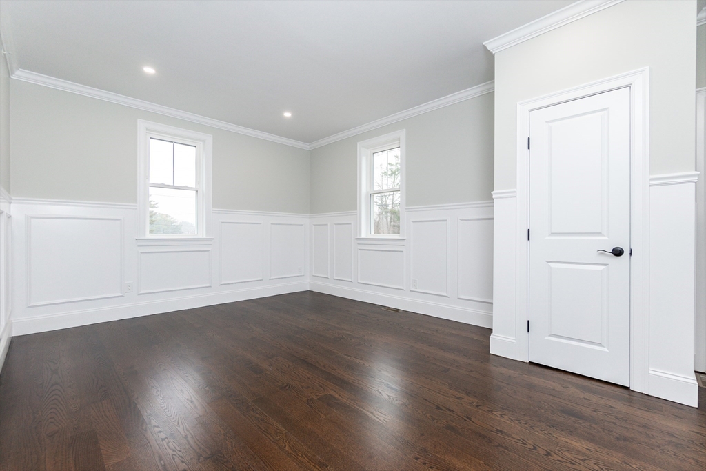 83 East Main Street Hopkinton, MA 01748 - Photo 8 of 42 an empty room with wooden floor and windows