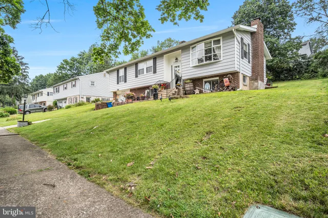 a view of a house with a yard and sitting area