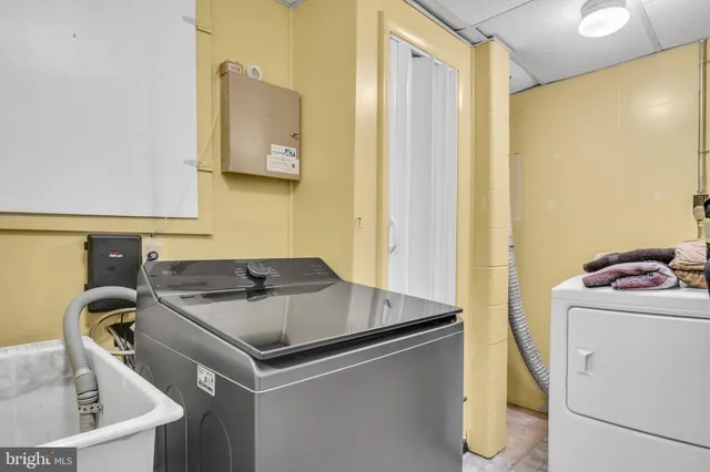 a utility room with a sink dryer and washer