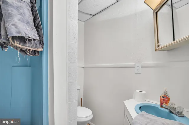 a bathroom with a toilet a sink and a shower