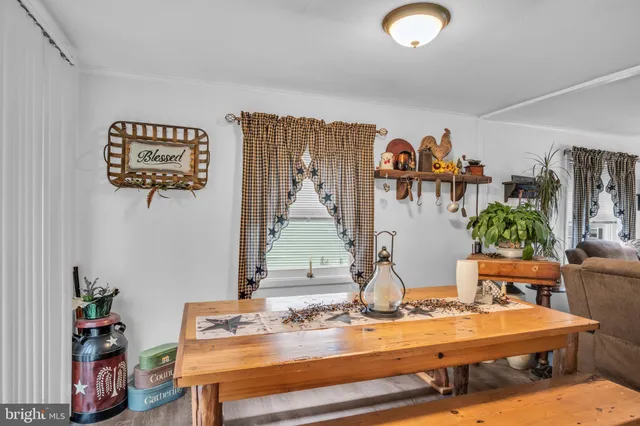 a room with furniture and view of kitchen