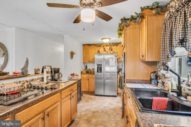 a kitchen with refrigerator a stove and a sink