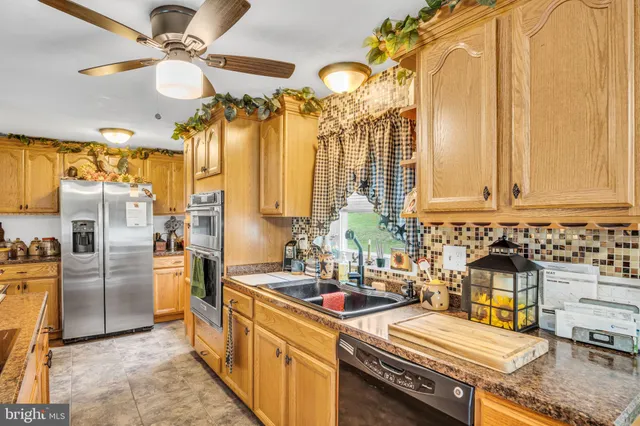 a kitchen with stainless steel appliances a stove a sink and a refrigerator