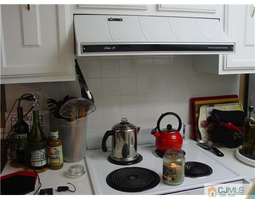 230 Convent Road Monroe Township, NJ 08831 - Photo 4 of 14 a kitchen with a stove and a wooden floor
