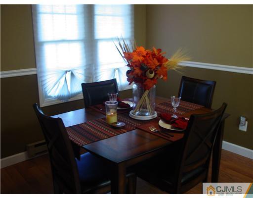 230 Convent Road Monroe Township, NJ 08831 - Photo 6 of 14 a dining room with furniture and wooden floor