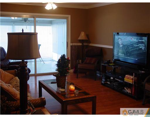 230 Convent Road Monroe Township, NJ 08831 - Photo 8 of 14 a living room with furniture and a lamp