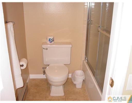 230 Convent Road Monroe Township, NJ 08831 - Photo 9 of 14 a bathroom with a toilet and a shower