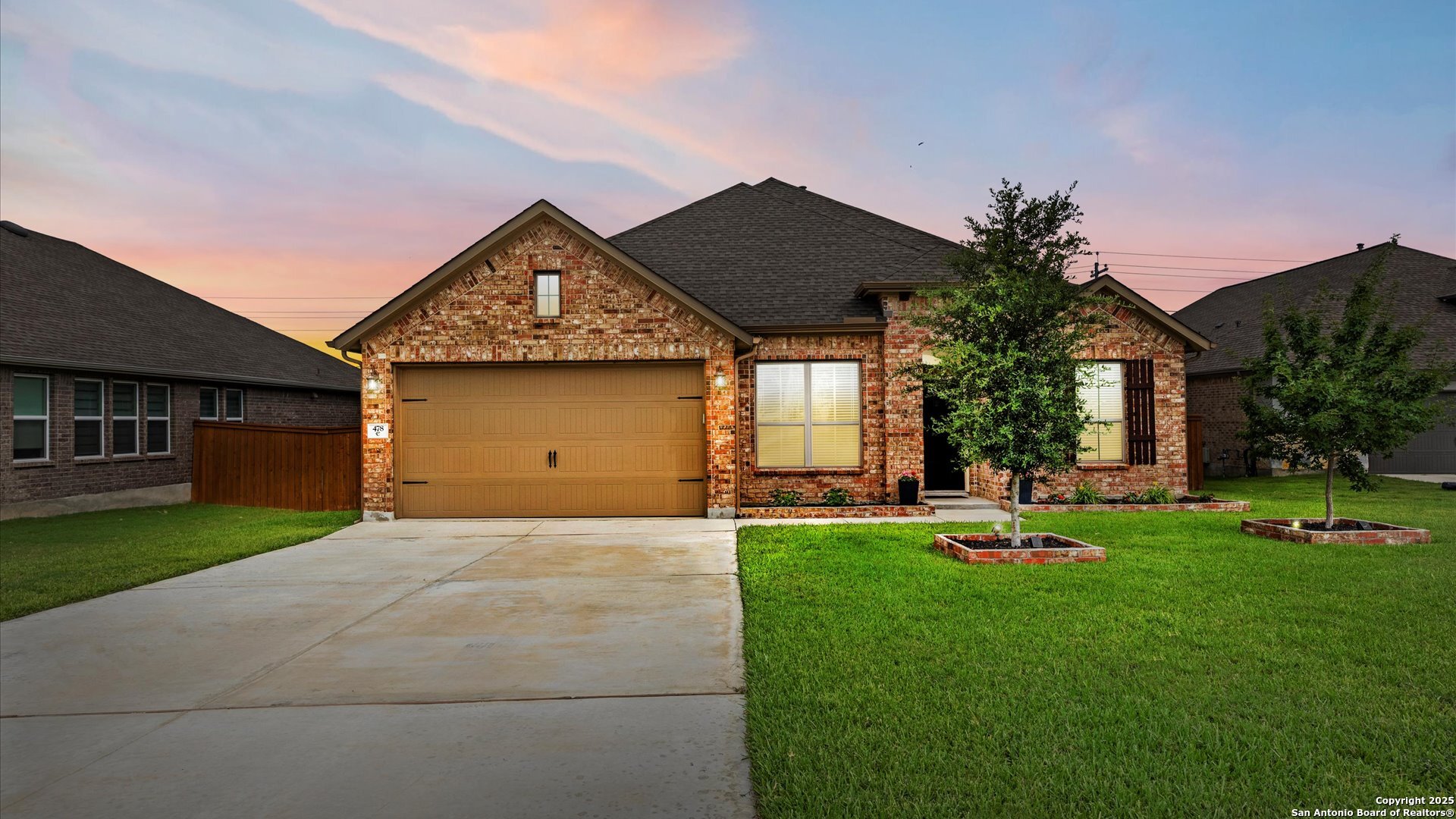 a front view of a house with a garden and patio