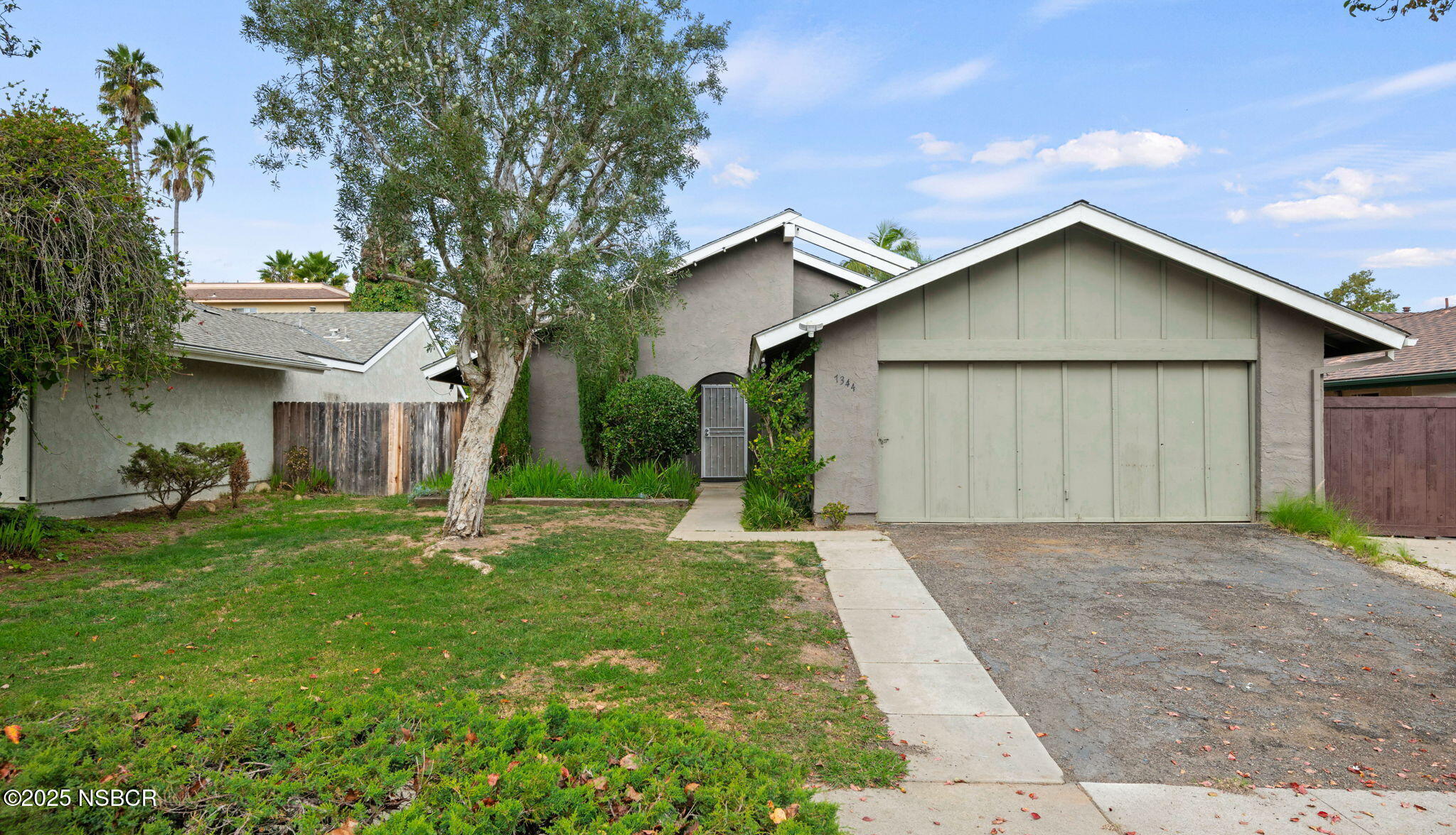 7344 Davenport Road Goleta, CA 93117 - Photo 1 of 21 a view of a house with a yard and large tree