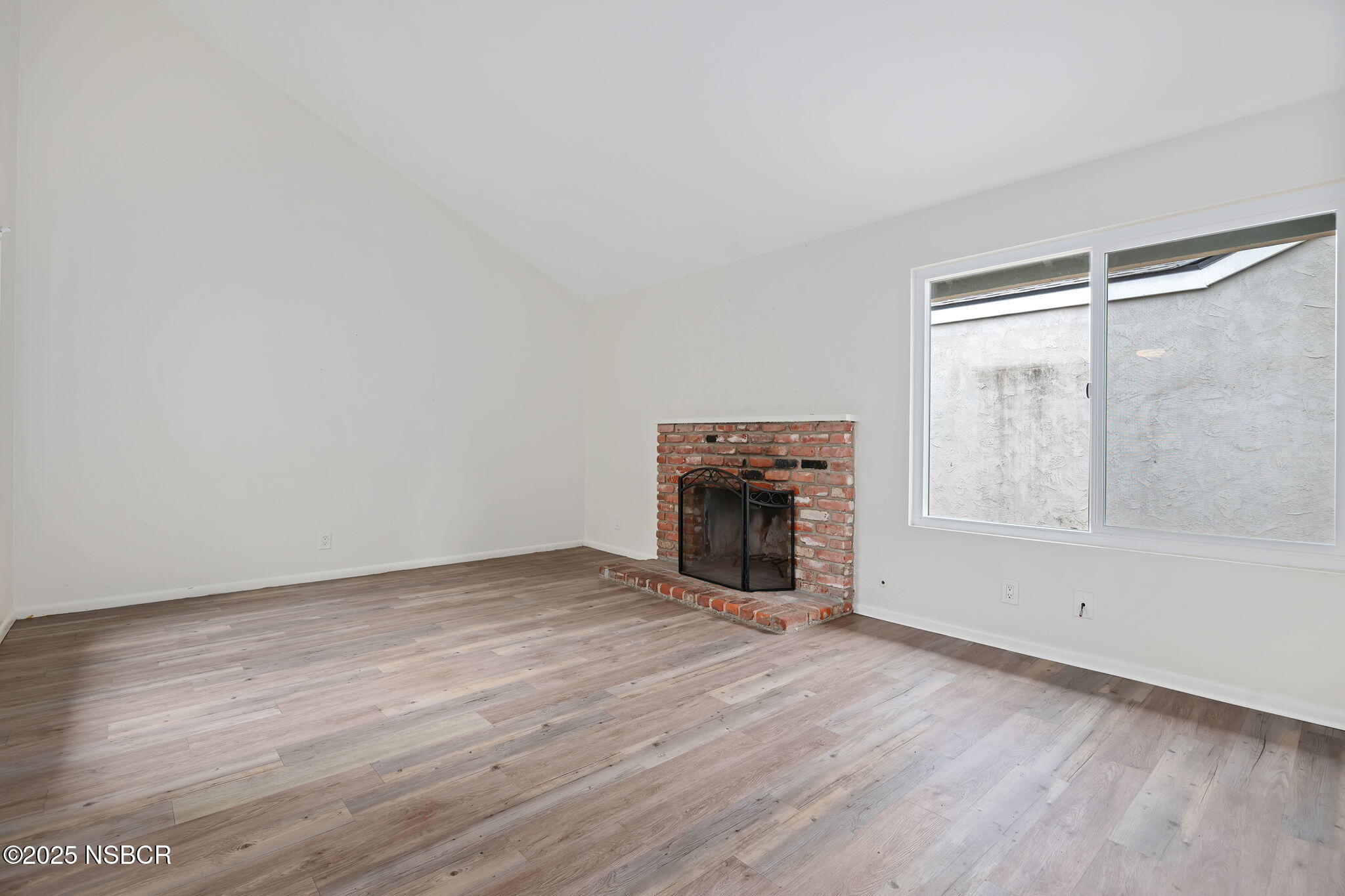 7344 Davenport Road Goleta, CA 93117 - Photo 5 of 21 a view of empty room with wooden floor and fireplace