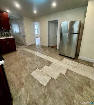 a view of a refrigerator in kitchen and wooden floor