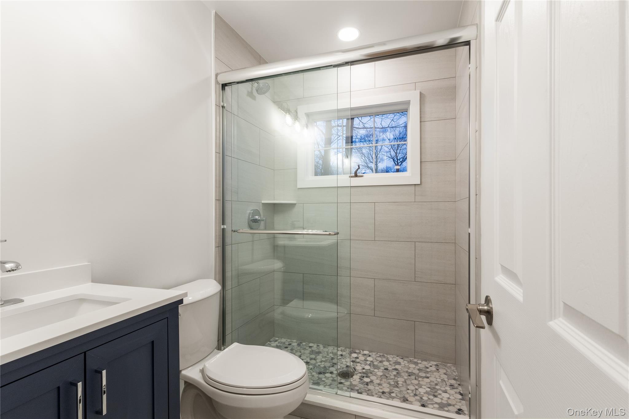 10 Overbrook Street Riverhead, NY 11901 - Photo 2 of 8 a bathroom with a toilet a sink and shower