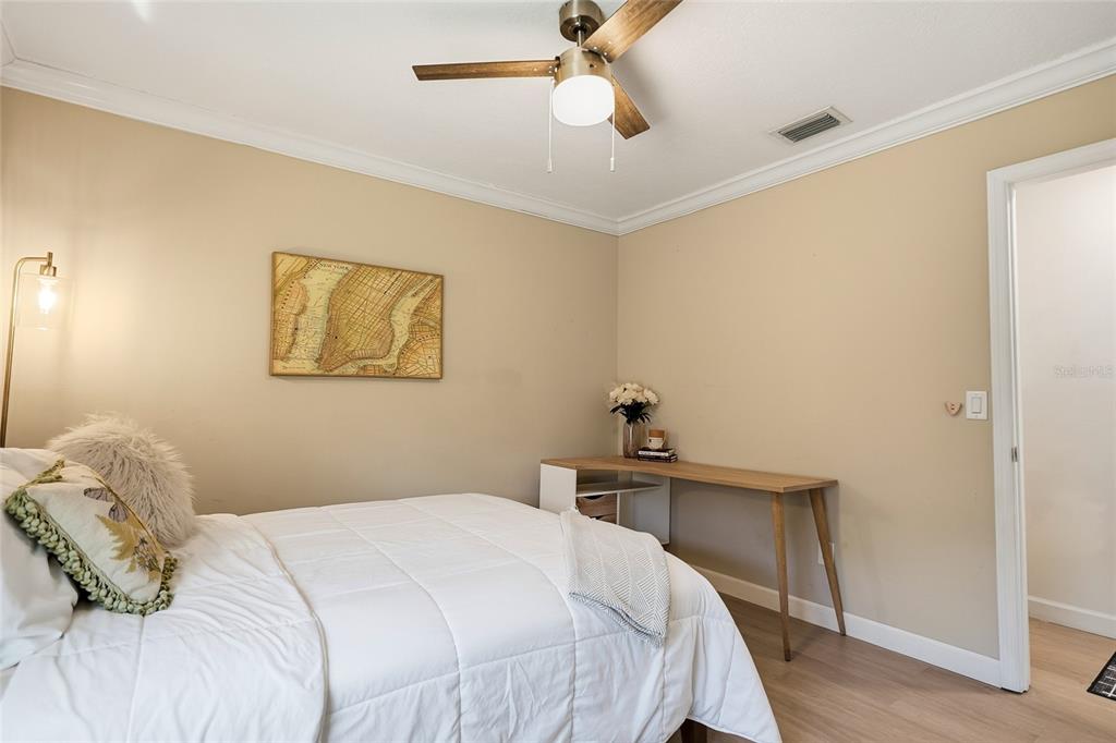4606 Buckeye Road Tampa, FL 33624 - Photo 30 of 39 a bedroom with a bed and a table
