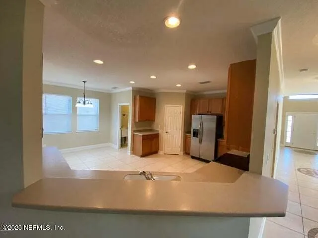 a view of a kitchen with a sink stainless steel appliances and cabinets