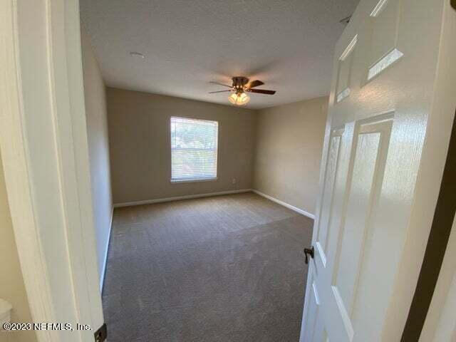 3301 Turkey Creek Drive Green Cove Springs, FL 32043 - Photo 13 of 36 an empty room with windows and fan
