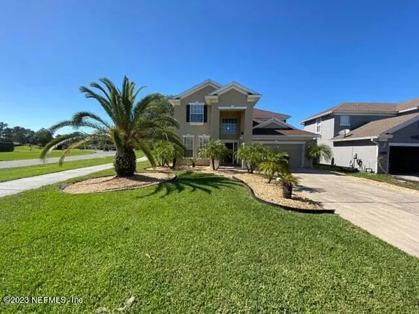 a view of a house with swimming pool and a yard