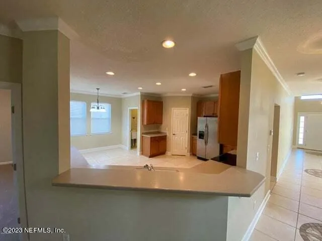 a large kitchen with stainless steel appliances a large counter top