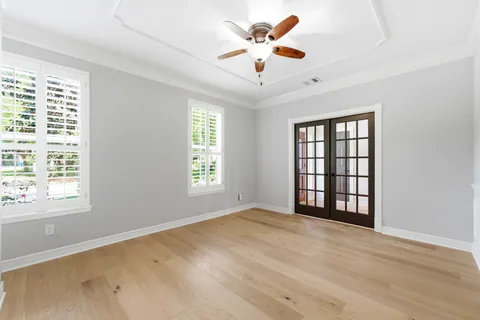 a view of an empty room with wooden floor