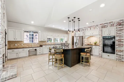 a kitchen with stainless steel appliances granite countertop a sink and stove