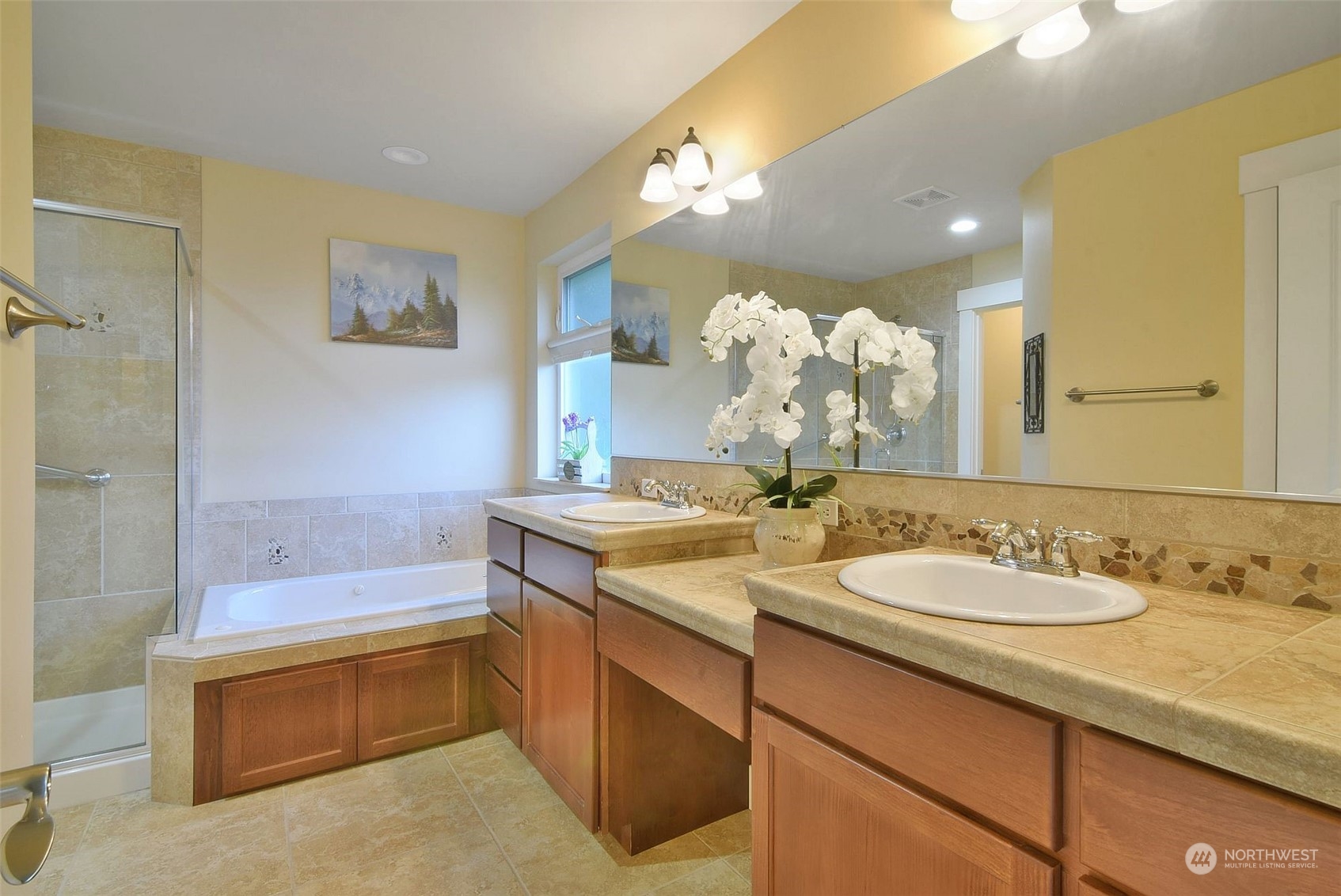 12 228th Street Southeast Bothell, WA 98021 - Photo 19 of 33 a bathroom with a granite countertop sink a large mirror and a bathtub