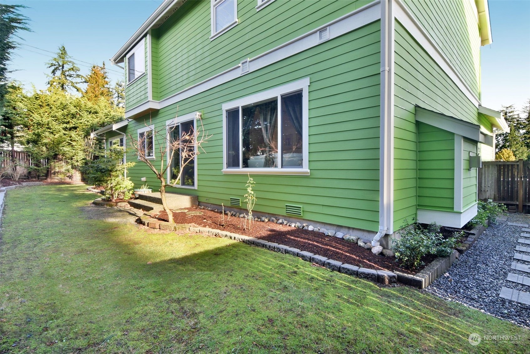 12 228th Street Southeast Bothell, WA 98021 - Photo 29 of 33 a view of a house with backyard sitting area and garden