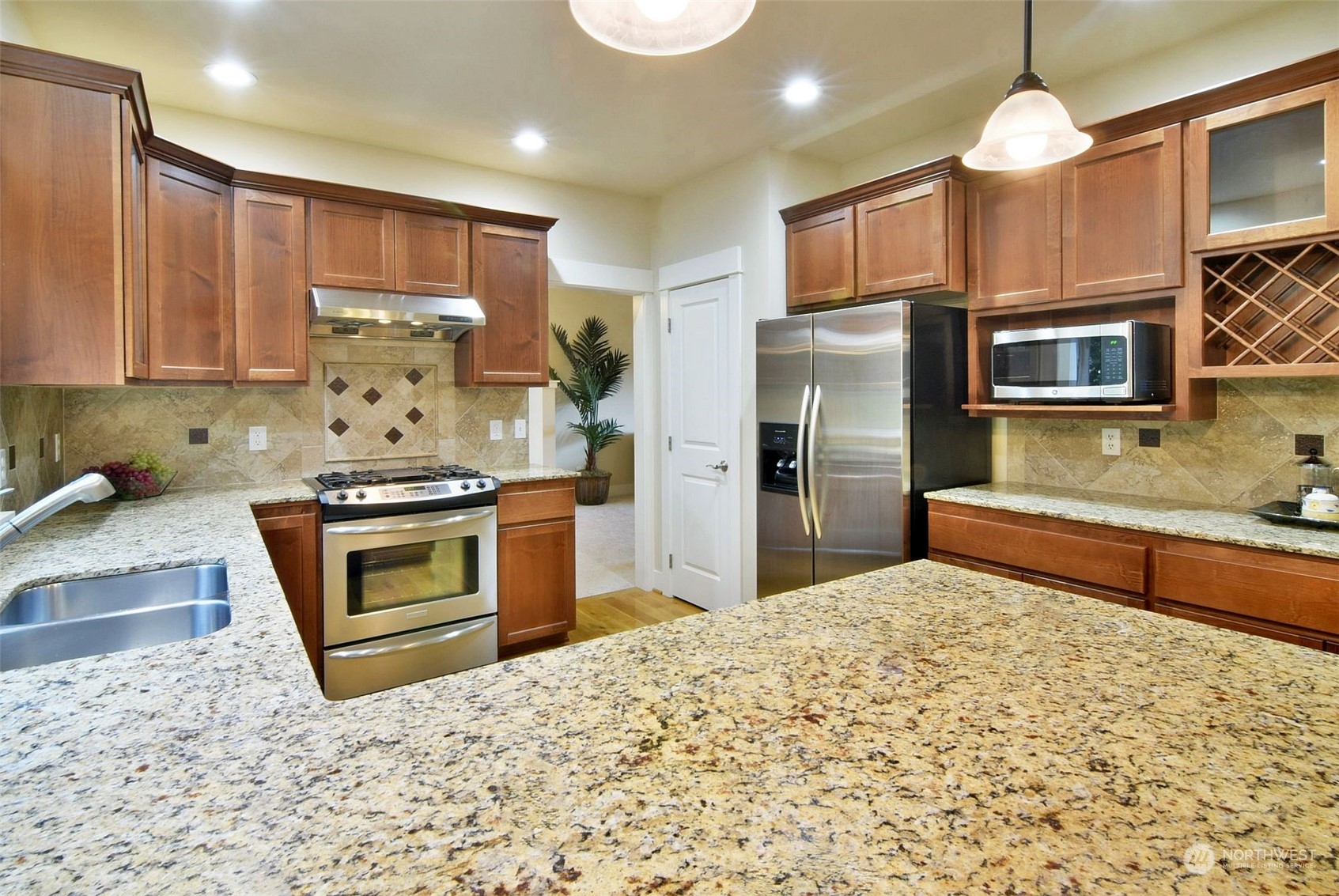 12 228th Street Southeast Bothell, WA 98021 - Photo 7 of 33 a kitchen with stainless steel appliances granite countertop a stove a sink and a refrigerator