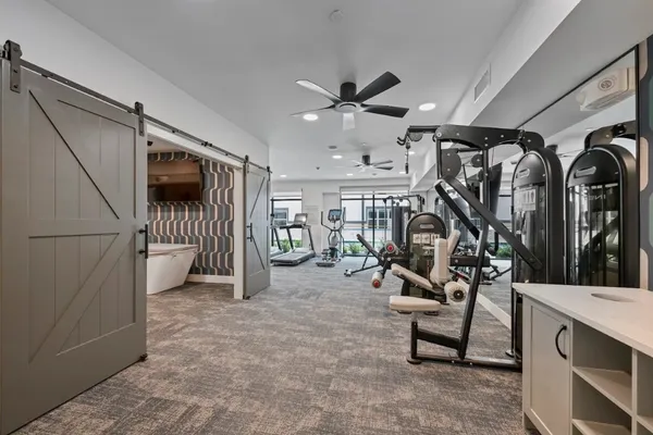 a living room with couch and a chandelier