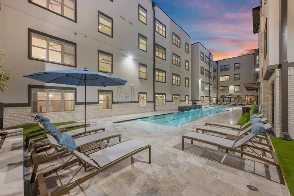 a view of a patio with a table and chairs