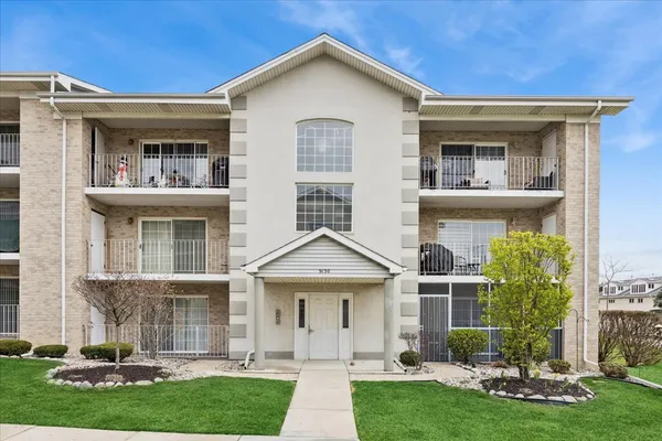 a front view of a house with a yard and plants