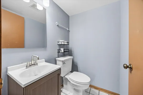 a bathroom with a sink toilet and a mirror