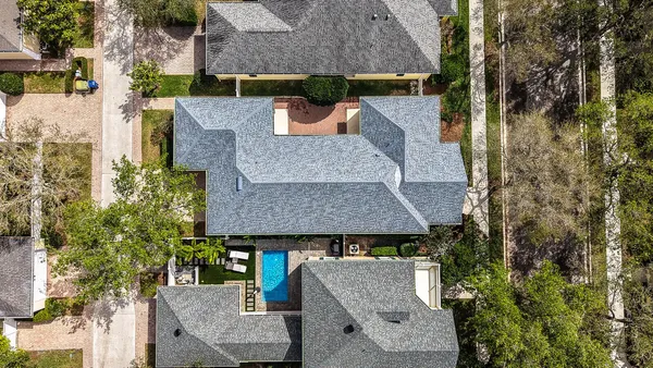 an aerial view of a house with swimming pool and porch