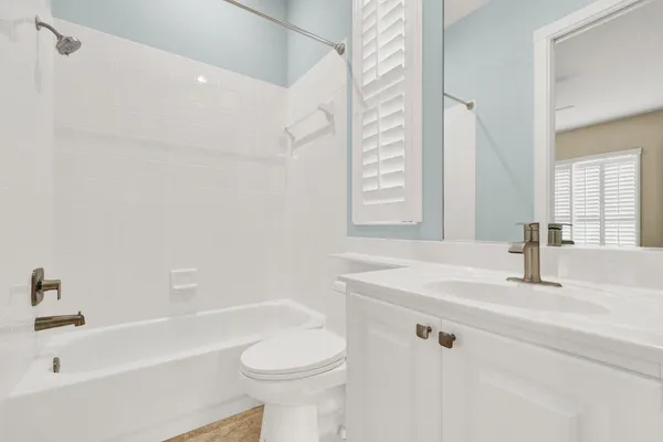 a bathroom with a sink a toilet and bathtub