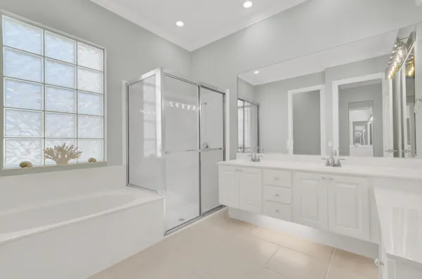 a spacious bathroom with a tub shower and sink