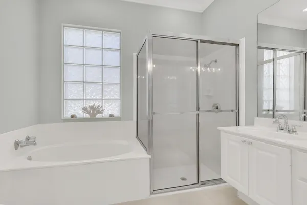 a white bath tub sitting next to a white sink