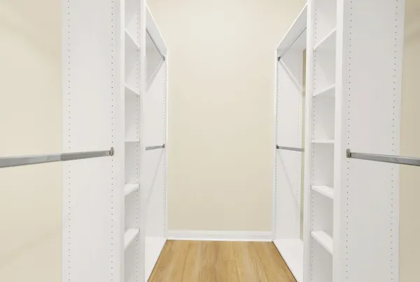 a view of walk in closet with wooden floor