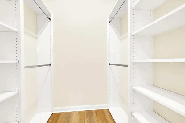 a view of walk in closet with empty racks
